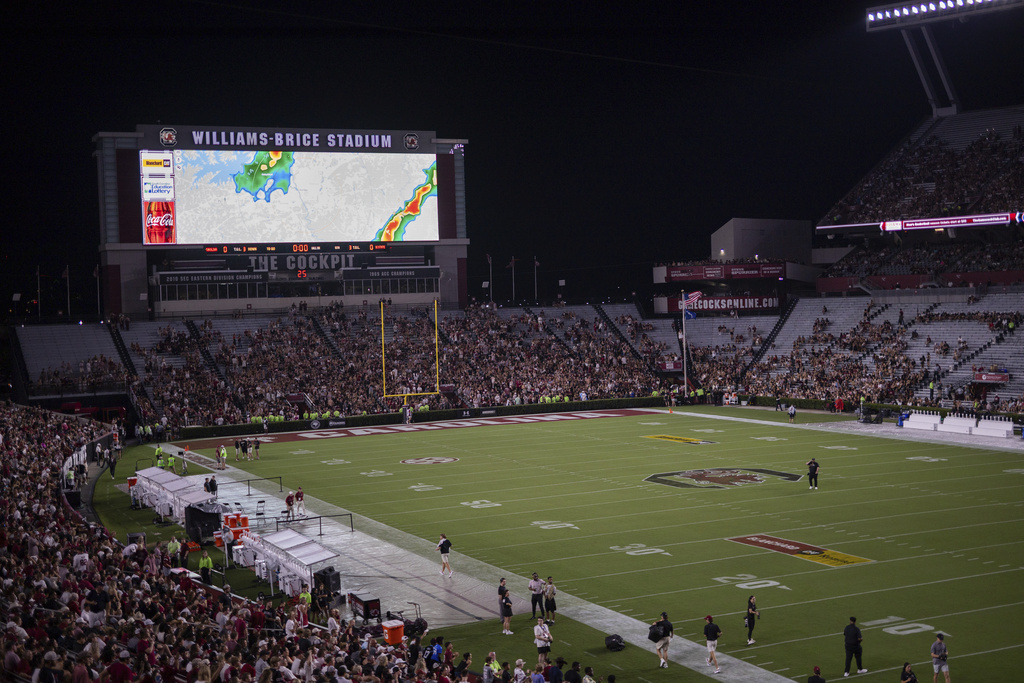 South Carolina fans wait during a rain delay for an NCAA college football game against South Carolina State, Saturday, Sept. 6, 2025, in Columbia, S.C. (AP Photo/Scott Kinser)