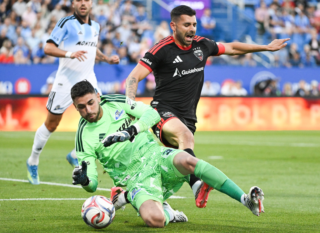 D.C. United's Tai Baribo, right, challenges CF Montreal goalkeeper Thomas Gillier (31) for the ball during the first half of a MLS soccer game in Montreal, on Saturday, Aug. 15, 2026. (Graham Hughes/The Canadian Press via AP)