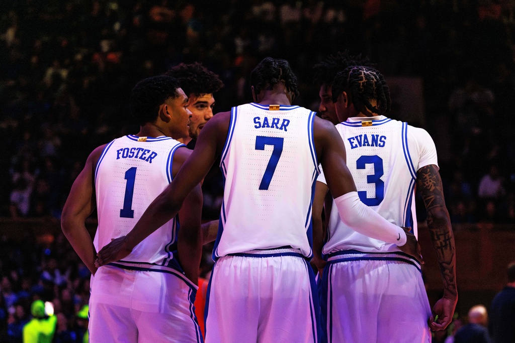 Duke's Caleb Foster (1), Dame Sarr (7), and Isaiah Evans (3) huddle with teammates before the start of the second half of an NCAA college basketball game against Virginia in Durham, N.C., Saturday, Feb. 28, 2026. (AP Photo/Ben McKeown)