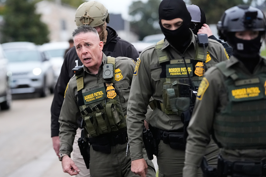 Customs and Border Patrol commander Gregory Bovino walks with border patrol agents through a neighborhood during an immigration crackdown, in Kenner, La., Friday, Dec. 5, 2025. (AP Photo/Gerald Herbert)