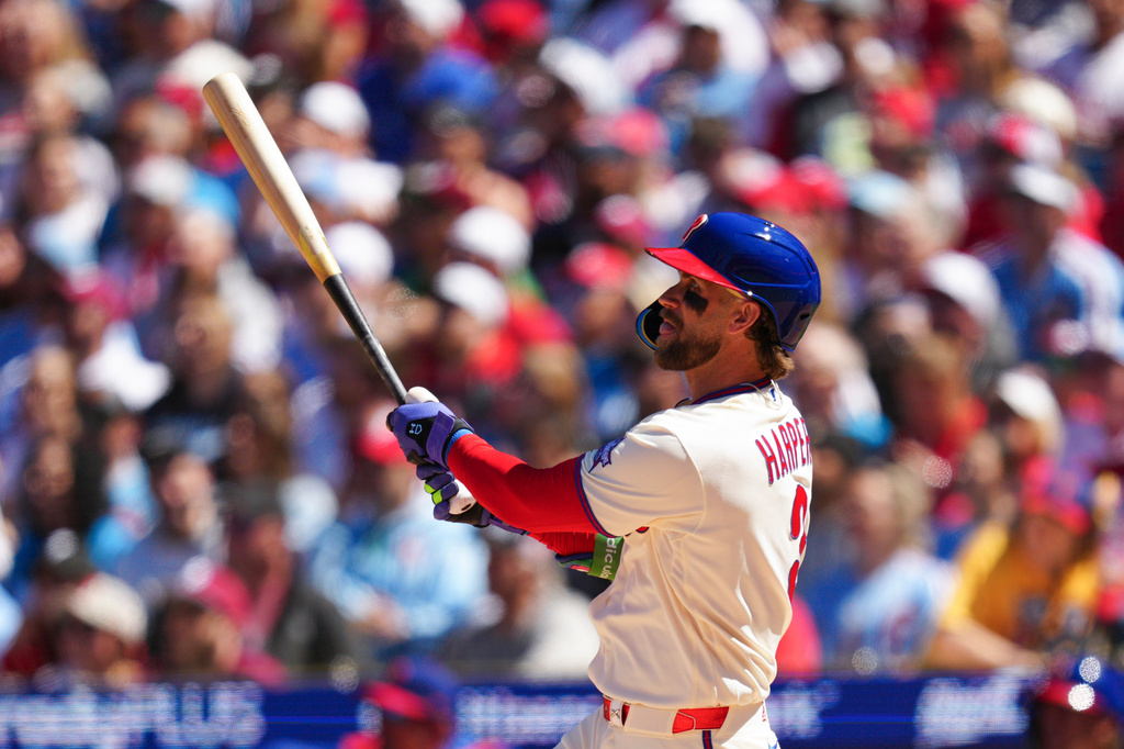 Philadelphia Phillies' Bryce Harper watches his solo home run off Arizona Diamondbacks pitcher Brandon Pfaadt during the third inning of a baseball game, Saturday, April 11, 2026, in Philadelphia. (AP Photo/Derik Hamilton)