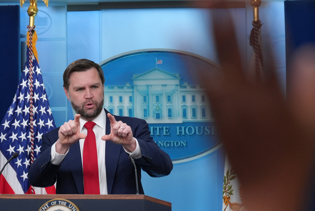 A reporter raises a hand to ask a question as Vice President JD Vance speaks in the James Brady Press Briefing Room at the White House, Thursday, June 18, 2026, in Washington. (AP Photo/Jacquelyn Martin)