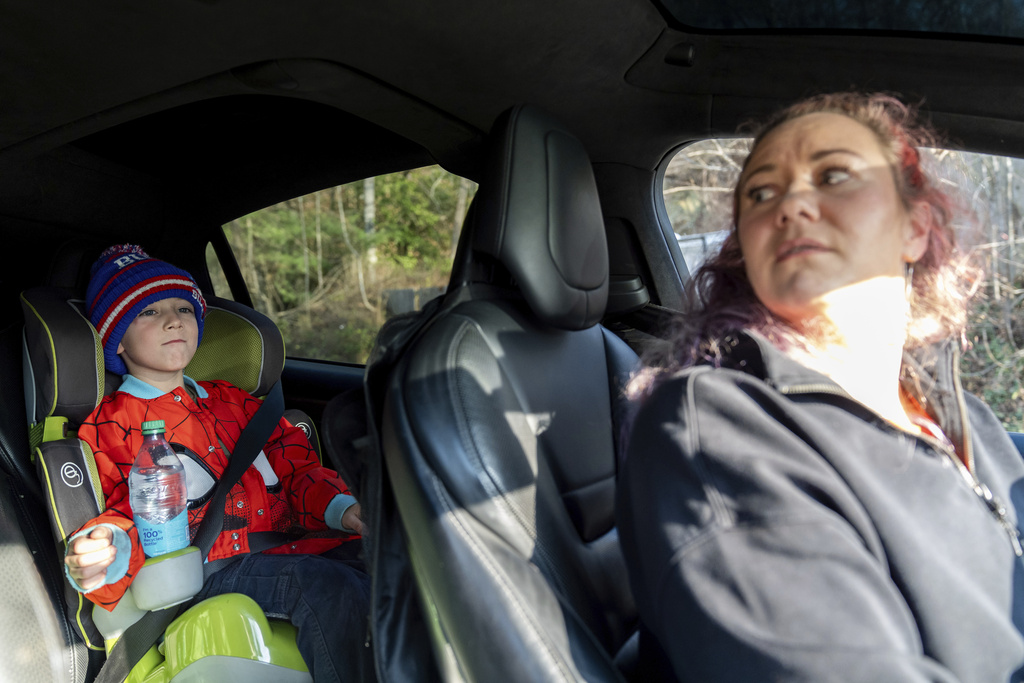 Terri Dolan, right, talks with her son, Fisher, after picking him up from school, Wednesday, Dec. 4, 2024, in Swannanoa, N.C. (AP Photo/Stephanie Scarbrough)
