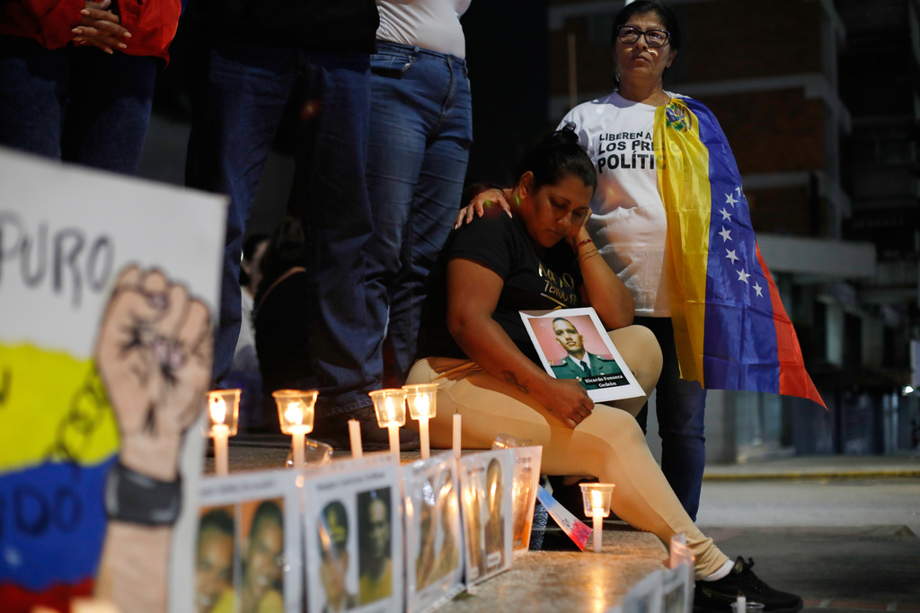Relatives of detainees they say are held for political reasons wait outside El Helicoide, headquarters of Venezuela's intelligence service and a detention center, after the National Assembly approved an amnesty bill in Caracas, Venezuela, Thursday, Feb. 19, 2026. (AP Photo/Crisitian Hernandez)