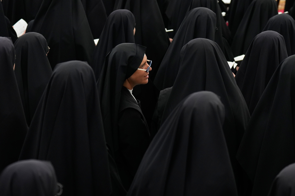 Nuns attend a consecration ceremony for four new bishops in a tent set up outside the Society of St. Pius X seminary, in Econe, Switzerland, Wednesday, July 1, 2026. (AP Photo/Baz Ratner)