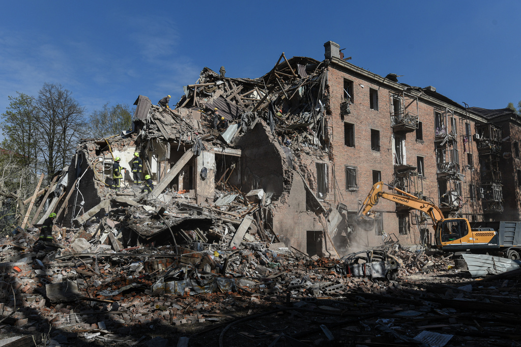 Rescue workers clear the rubble of a residential building destroyed by a Russian strike, in Dnipro, Ukraine, Saturday, April 25, 2026. (AP Photo/Mykola Synelnykov)