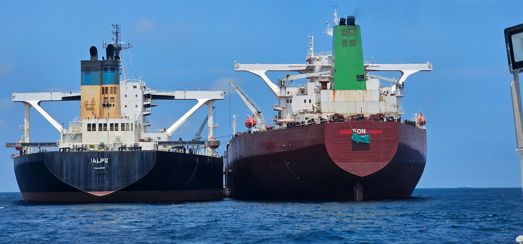 This handout photo from United Against Nuclear Iran shows two oil tankers making a ship-to-ship transfer of Iranian oil in the Eastern Outer Port Limits (EOPL), 70 kilometers off Malaysia's coast in international waters on 28 July 2025. (Charlie Brown/United Against Nuclear Iran via AP)