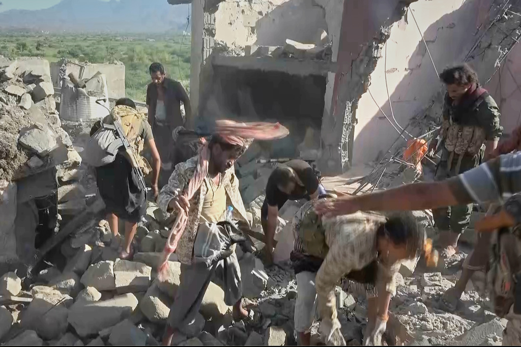 This image taken from video released by Al-Masirah TV, a channel run by Yemen's Houthi rebels, on Monday, Sept. 28, 2026, shows what the channel said were Houthi fighters and local residents searching through the rubble of a house following a strike by Saudi-backed forces in the town of Kadhah, in Taiz province, Yemen. (Al-Masirah TV via AP)