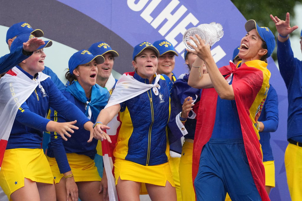 Carlota Ciganda of Europe holds the trophy as she celebrates with teammates after they won the Solheim Cup in Den Bosch, Netherlands, Sunday, Sept. 13, 2026. (AP Photo/Alastair Grant)