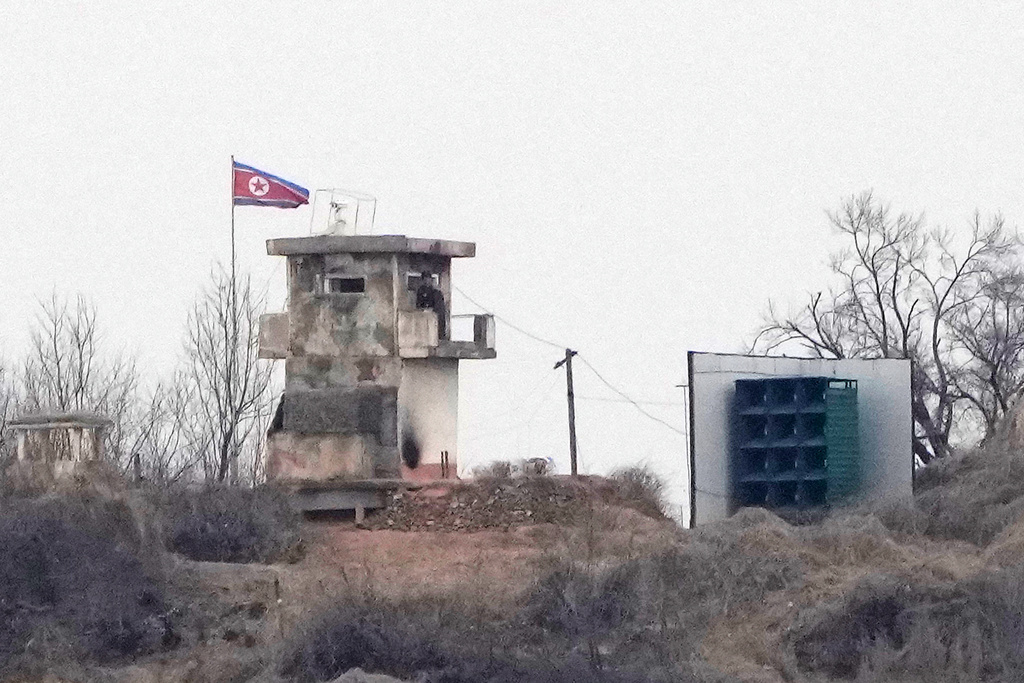 A soldier stands at a North Korean military guard post flying a national flag, seen from Paju, South Korea, near the border with North Korea, Thursday, Feb. 26, 2026. (AP Photo/Ahn Young-joon)