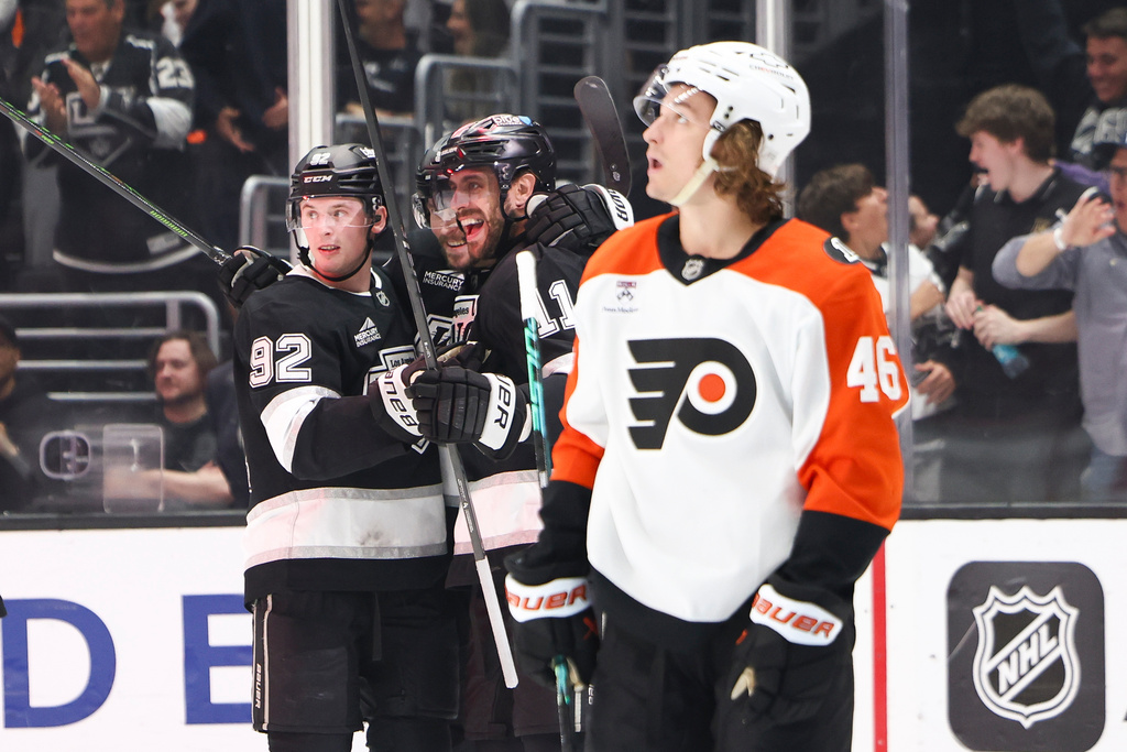 Los Angeles Kings center Anze Kopitar, second from right, celebrates with right wing Adrian Kempe, third from right, and defenseman Brandt Clarke, left, as Philadelphia Flyers center Trevor Zegras (46) looks on during the second period of an NHL hockey game, Thursday, March 19, 2026, in Los Angeles. (AP Photo/Jessie Alcheh)