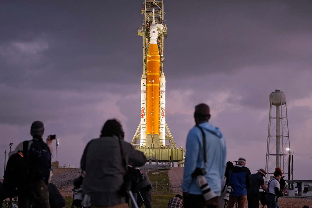 Photographers set up remote cameras near NASA's Artermis II moon rocket on Launch Pad 39-B just before sunrise at the Kennedy Space Center Tuesday, March 31, 2026, in Cape Canaveral, Fla. (AP Photo/Chris O'Meara)