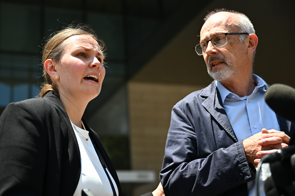 From left, Leah Rinderknecht, sister of Jonathan Rinderknecht speaks as her father Joel Rinderknecht, listens, outside federal court after a federal judge declared a mistrial in the arson case against Jonathan Rinderknecht, who is accused of sparking the deadly 2025 Palisades Fire, on Friday, June 26, 2026, in Los Angeles. (AP Photo/William Liang)