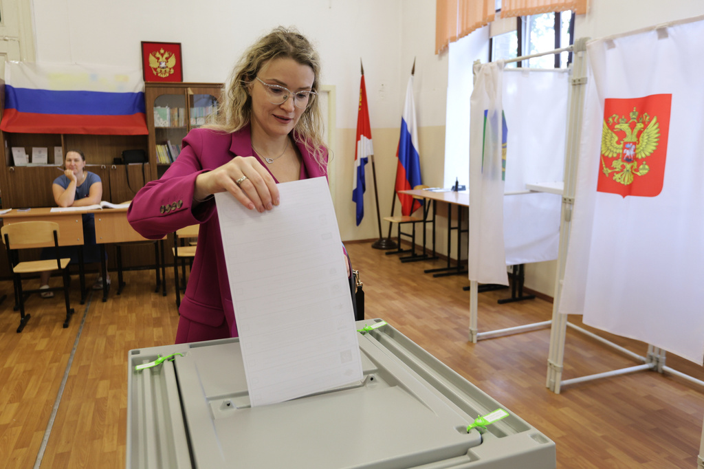 A woman casts her ballot in the parliamentary election in Vladivostok, Russia, Friday, Sept. 18, 2026. (AP Photo)