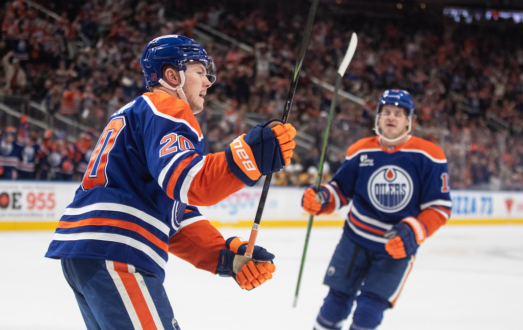 Edmonton Oilers' Curtis Lazar (20) and Mattias Janmark (13) celebrate a goal against the Nashville Predators during second period NHL action, in Edmonton, Tuesday, Jan. 6, 2026. (Jason Franson/The Canadian Press via AP)