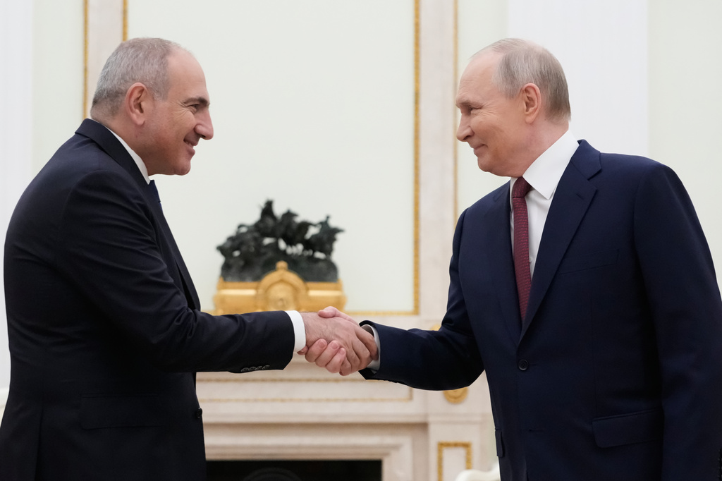 Russian President Vladimir Putin, right, and Armenian Prime Minister Nikol Pashinyan greet each other during their meeting at the Kremlin in Moscow, Russia, Wednesday, April 1, 2026. (AP Photo/Pavel Bednyakov, Pool)