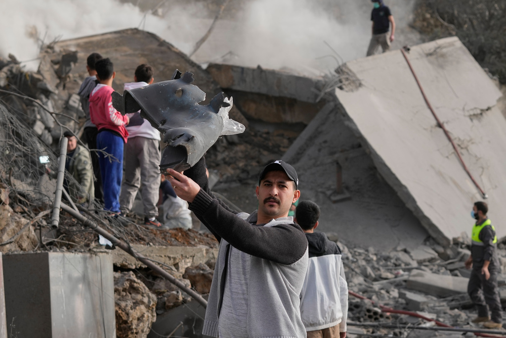 FILE - A man shows part of an Israeli missile following an airstrike that hit a building in Ain Qana village, south Lebanon, Feb. 2, 2026. (AP Photo/Mohammed Zaatari, File)