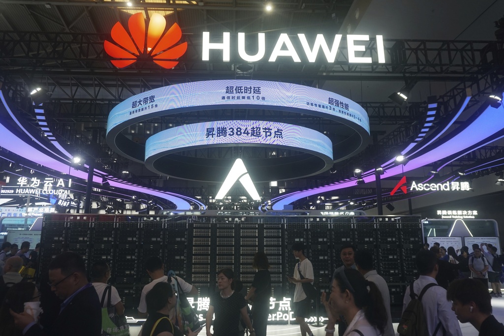 Visitors pass by the Huawei Atlas 900 A3 SuperPoD exhibited at the World Artificial Intelligence Conference in Shanghai, China, July 28, 2025. (Chinatopix Via AP) CHINA OUT