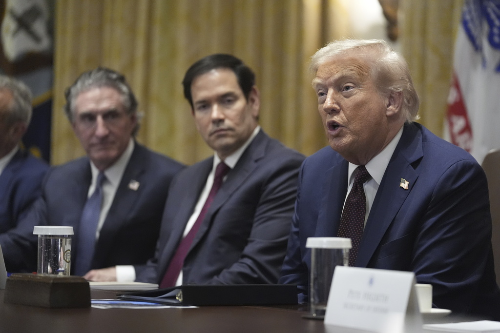 President Donald Trump speaks during a cabinet meeting, Tuesday, Aug. 26, 2025, at the White House in Washington, as from left, Secretary of Interior Doug Burgum and Secretary of State Marco Rubio, look on. (AP Photo/Mark Schiefelbein)