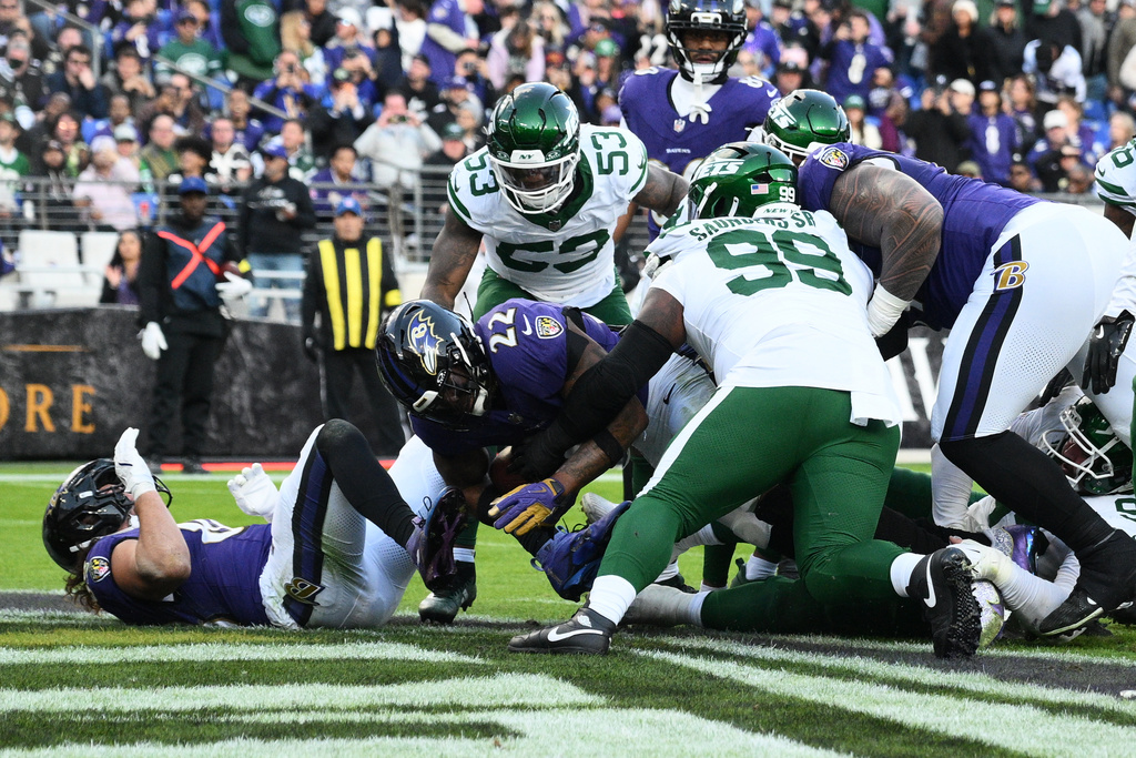 Baltimore Ravens running back Derrick Henry (22) scores a touchdown during the second half of an NFL football game against the New York Jets, Sunday, Nov. 23, 2025, in Baltimore. (AP Photo/Nick Wass)