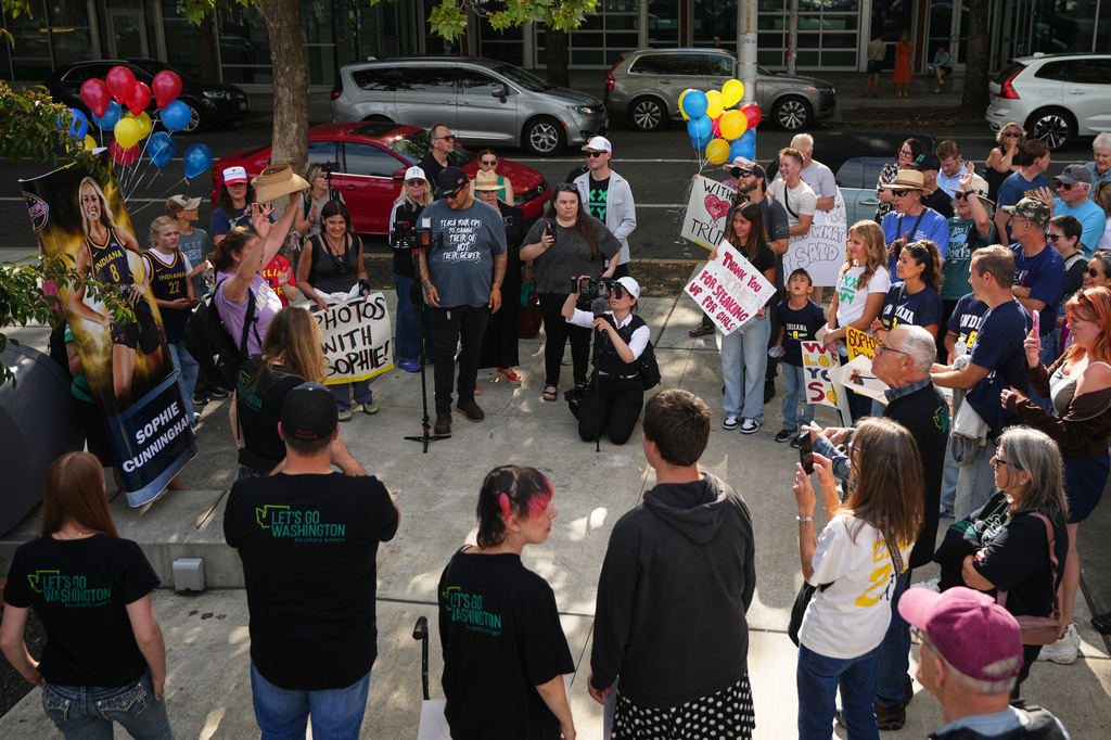 People rally to support Indiana Fever guard Sophie Cunningham after her comments on transgender athletes in women's sports before a WNBA basketball game between the Seattle Storm and the Indiana Fever, Tuesday, July 28, 2026, in Seattle. (AP Photo/Lindsey Wasson)