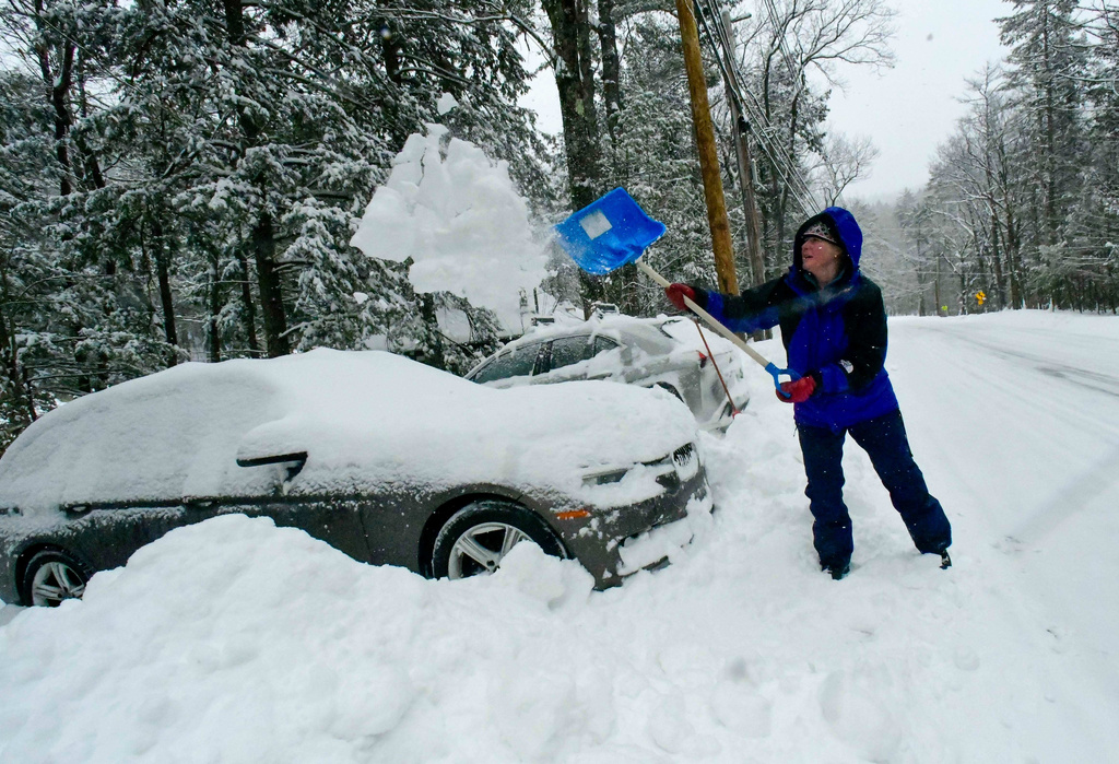 Katherine Schneider shovels out a vehicle for the fourth time during the storm on Route 100 on Monday, Jan. 26, 2026, in Jamaica, Vt., after Winter Storm Fern dropped several inches of snow. (Kristopher Radder/The Brattleboro Reformer via AP)