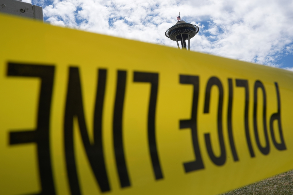 Police tape cordons off an area near the Space Needle the day after a shooting at Seattle Center during the Bite of Seattle food festival, Monday, July 27, 2026. (AP Photo/Lindsey Wasson)