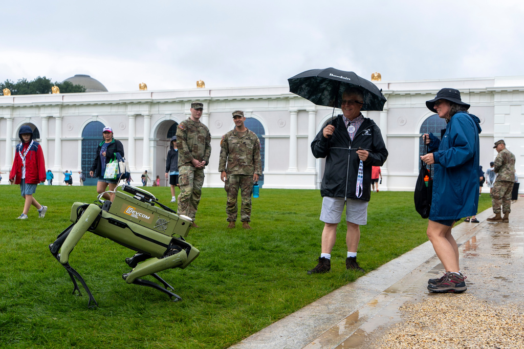 People dance with a U.S. Army robotic dog at the Great American State Fair on the National Mall, Sunday June 28, 2026, in Washington. (AP Photo/Jen Golbeck)