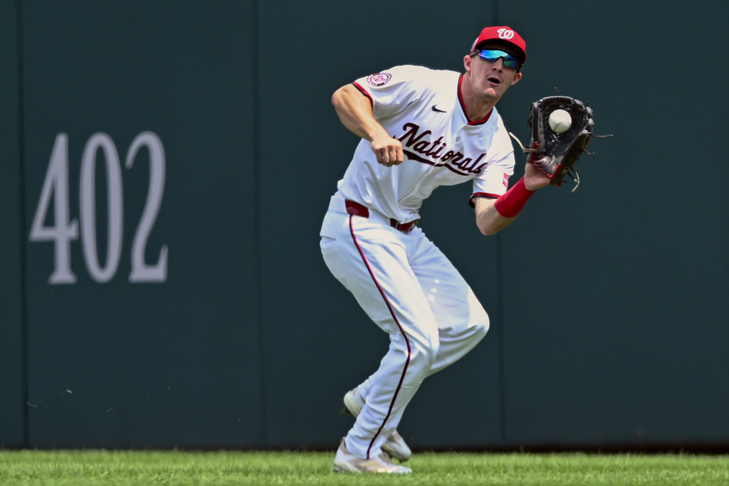 Washington Nationals center fielder Jacob Young catches a deep fly ball hit by the Athletics' Shea Langeliers during the first inning of a baseball game Thursday, Aug. 7, 2025, in Washington. (AP Photo/John McDonnell)