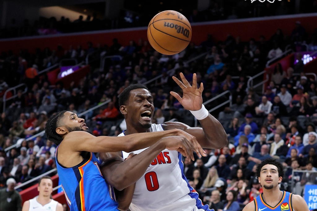 Oklahoma City Thunder guard Isaiah Joe fouls Detroit Pistons center Jalen Duren (0) while going to the basket during the first half of an NBA basketball game, Wednesday, Feb. 25, 2026, in Detroit. (AP Photo/Duane Burleson)