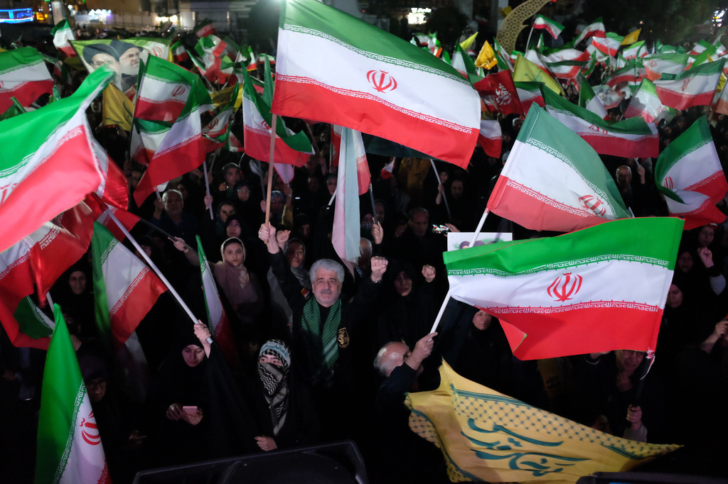 Pro-government demonstrators wave Iranian flags during a gathering in Tehran, Iran, Saturday, April 11, 2026. (AP Photo/Vahid Salemi)