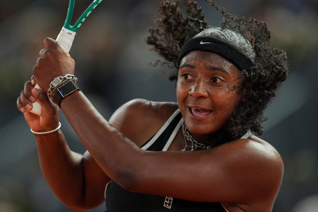 Hailey Baptiste, of the United States, returns the ball to Aryna Sabalenka, of Belarus, during the Madrid Open tennis tournament in Madrid, Tuesday, April 28, 2026. (AP Photo/Manu Fernandez)