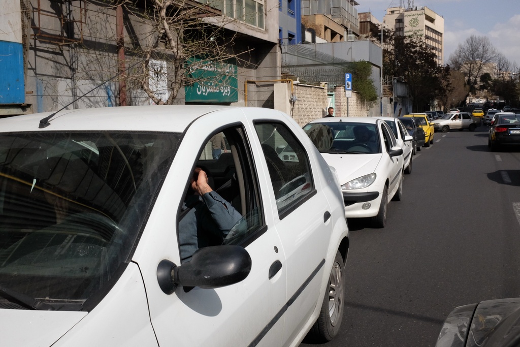 Vehicles queue outside a gas station following Israeli strikes in the city, in Tehran, Iran, Saturday, Feb. 28, 2026. (AP Photo/Vahid Salemi)