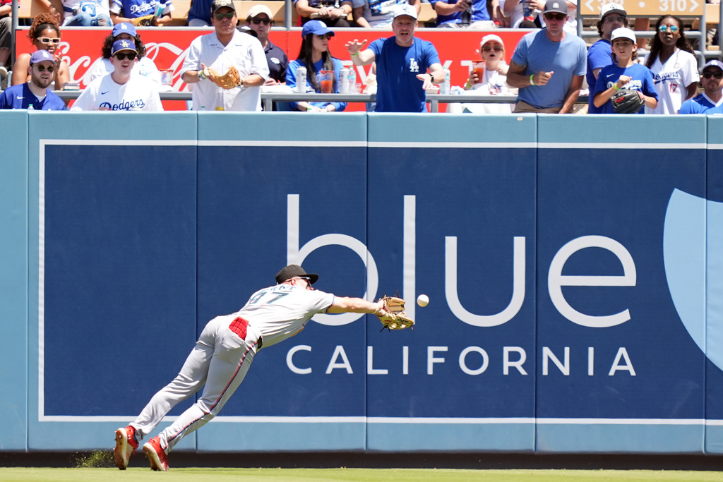 Miami Marlins' Jakob Marsee (87) can't catch a double hit by Los Angeles Dodgers' Max Muncy in the third inning of a baseball game Wednesday, April 29, 2026, in Los Angeles. (AP Photo/Scott Strazzante)