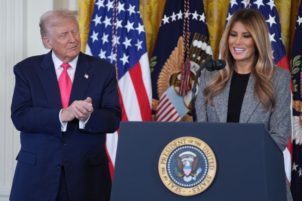 President Donald Trump listens as first lady Melania Trump speaks during an event on foster care in the East Room of the at the White House, Thursday, Nov. 13, 2025, in Washington. (AP Photo/Evan Vucci)
