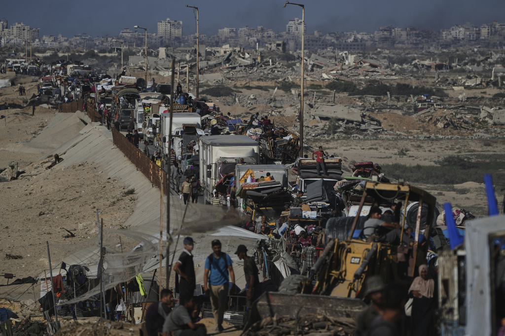 Displaced Palestinians fleeing northern Gaza carry their belongings along the coastal road toward southern Gaza, Wednesday, Sept. 10, 2025, after the Israeli army issued evacuation orders from Gaza City. (AP Photo/Abdel Kareem Hana)