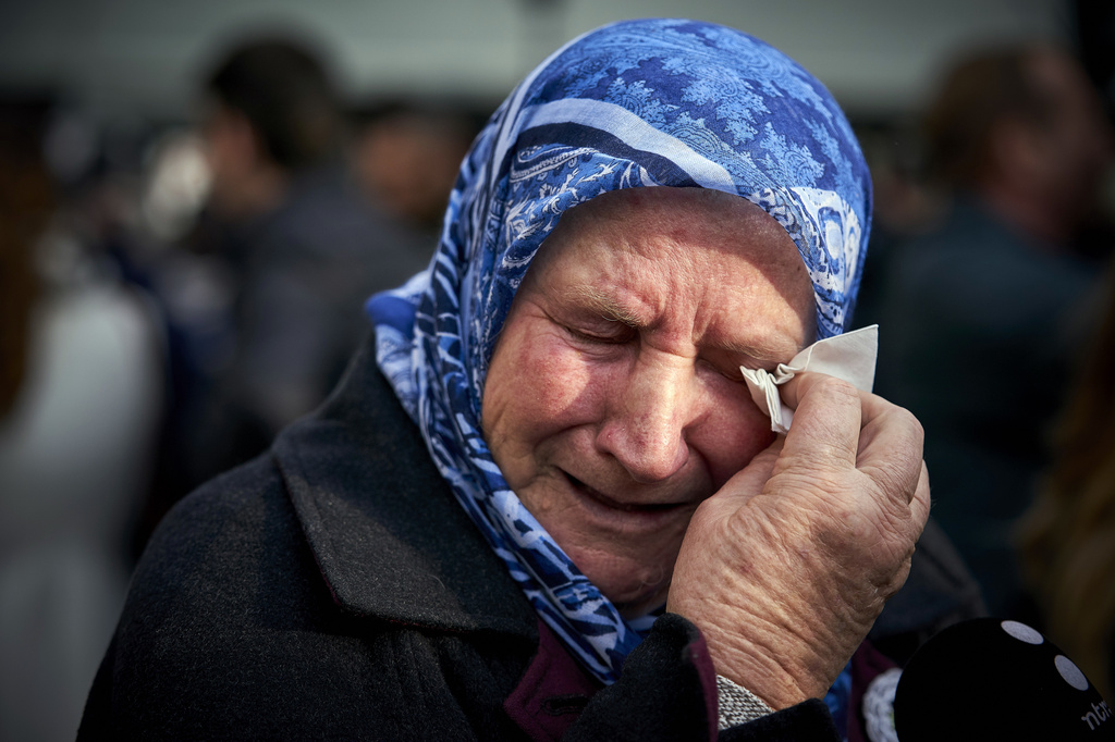 FILE - Nura Mustafic, one of the Mothers of Srebrenica and other Bosnian organizations, wipes away tears as she reacts to the verdict which the Yugoslav War Crimes Tribunal, ICTY, handed down in the genocide trial against former Bosnian Serb military chief Ratko Mladic, in The Hague, Netherlands, Wednesday Nov. 22, 2017. (AP Photo/Phil Nijhuis, File)