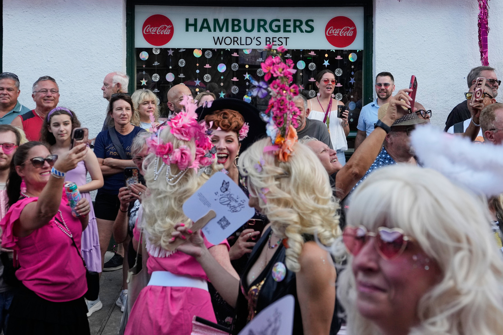 Members of the Krewe of Dolly lead a second line parade in commemoration of the life of Dolly Parton through the French Quarter Friday, Sept. 25, 2026, in New Orleans. (AP Photo/Gerald Herbert)