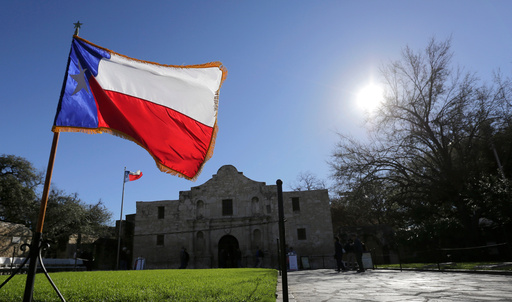 FILE - The Texas flag waves in front of the Alamo during a reenactment of the delivery of William B. Travis' "Victory or Death" letter, Wednesday, Feb. 24, 2016, in San Antonio. (AP Photo/Eric Gay, File) FILE - The Texas flag waves in front of the Alamo during a reenactment of the delivery of William B. Travis' "Victory or Death" letter, Wednesday, Feb. 24, 2016, in San Antonio. (AP Photo/Eric Gay, File)