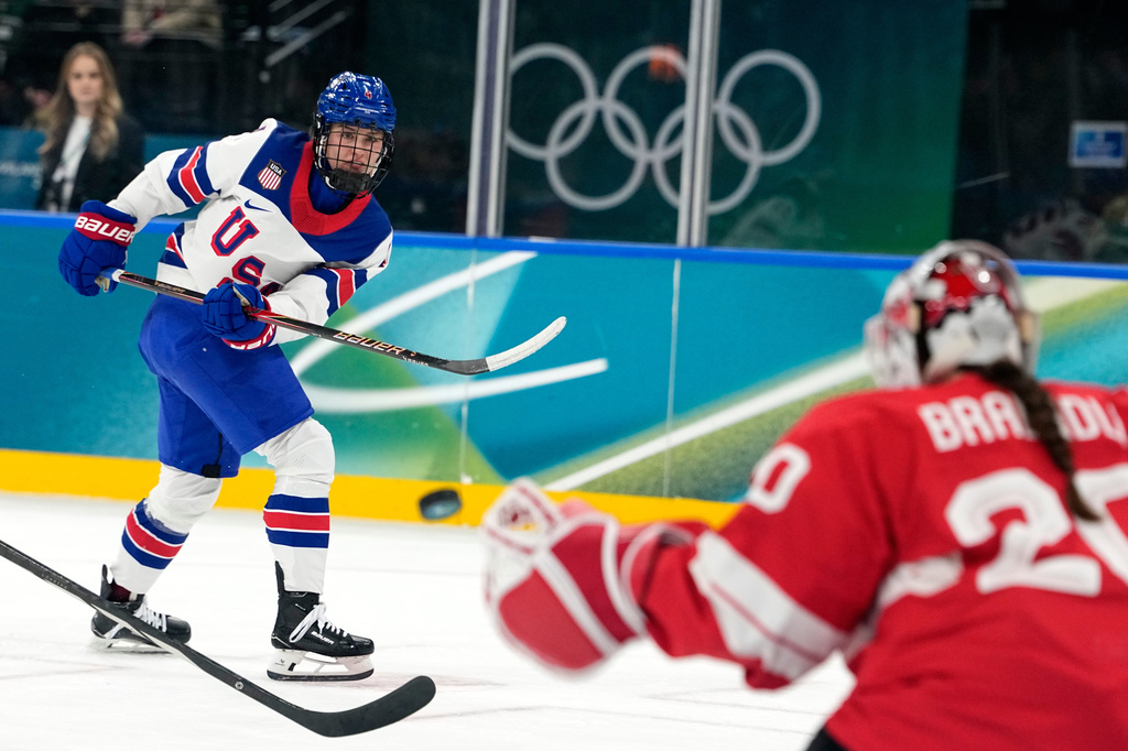 FILE - United States' Caroline Harvey shoots on goal during a preliminary round match of women's ice hockey between Switzerland and United States at the 2026 Winter Olympics, in Milan, Italy, Feb. 9, 2026. (AP Photo/Hassan Ammar, File)