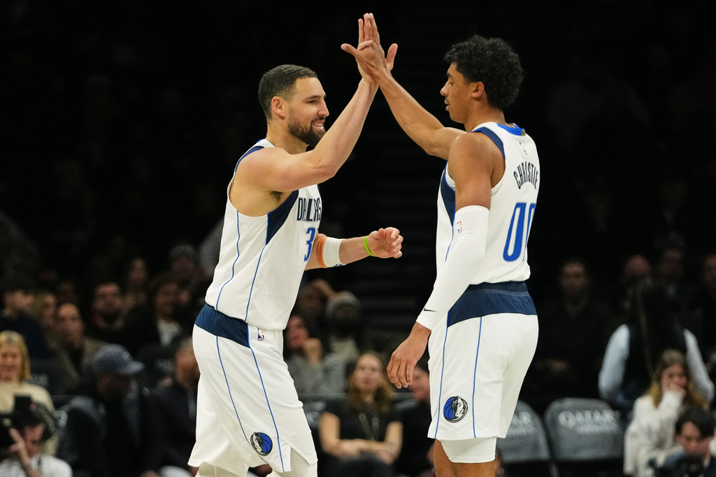 Dallas Mavericks' Klay Thompson, left, celebrates with Max Christie after making a three-point shot during the first half of an NBA basketball game against the Brooklyn Nets Tuesday, Feb. 24, 2026, in New York. (AP Photo/Frank Franklin II)