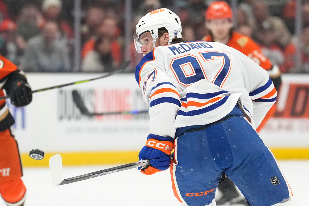 Edmonton Oilers center Connor McDavid watches as the puck flies in front of him during the first period of Game 3 in the first round of the NHL hockey Stanley Cup playoffs series against the Anaheim Ducks, Friday, April 24, 2026, in Anaheim, Calif. (AP Photo/Mark J. Terrill)