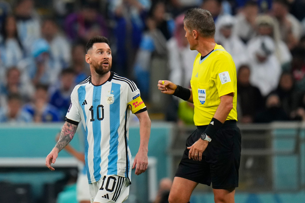 FILE - Referee Daniele Orsato talks to Argentina's Lionel Messi, left, during the World Cup semifinal soccer match between Argentina and Croatia at the Lusail Stadium in Lusail, Qatar, Dec. 13, 2022. (AP Photo/Petr David Josek, file)