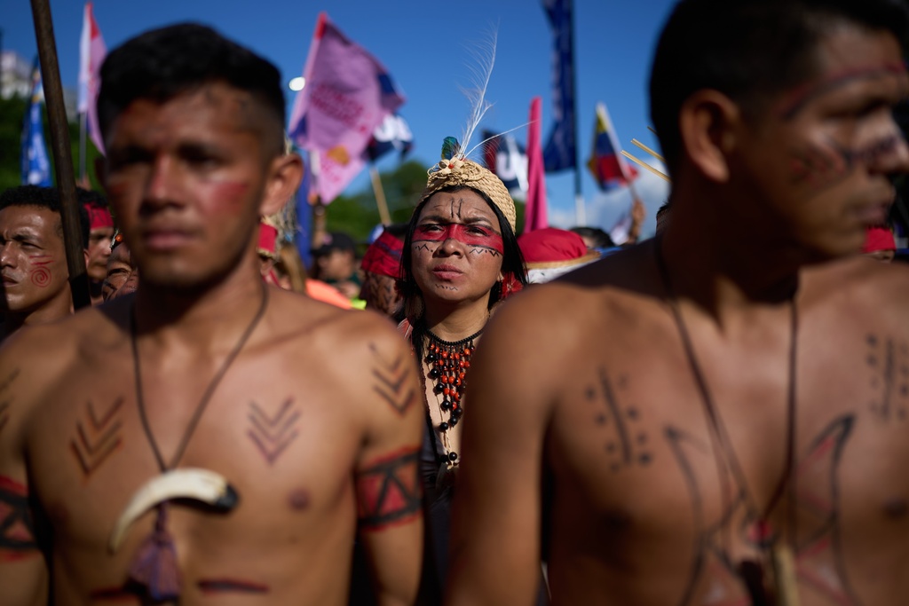 People take part in an event marking Indigenous Day in Caracas, Venezuela, Oct. 12, 2025. (AP Photo/Ariana Cubillos)