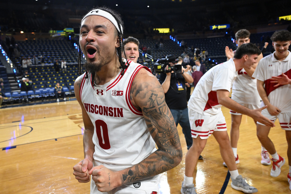 Wisconsin guard Braeden Carrington (0) celebrates with his teammates after they beat Michigan after an NCAA college basketball game in Ann Arbor, Mich., Saturday, January 10, 2026. (AP Photo/Lon Horwedel)