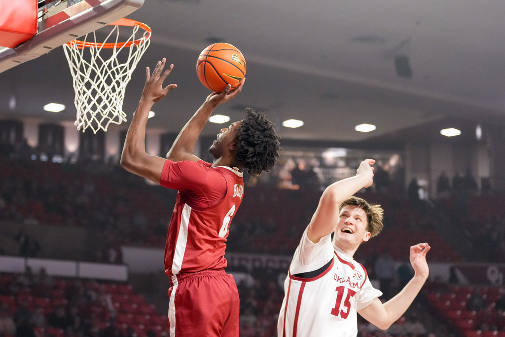 Alabama forward London Jemison (6) shoots in front of Oklahoma center Kirill Elatontsev (15) during the first half of an NCAA college basketball game, Saturday, Jan. 17, 2026, in Norman, Okla. (AP Photo/Kyle Phillips)