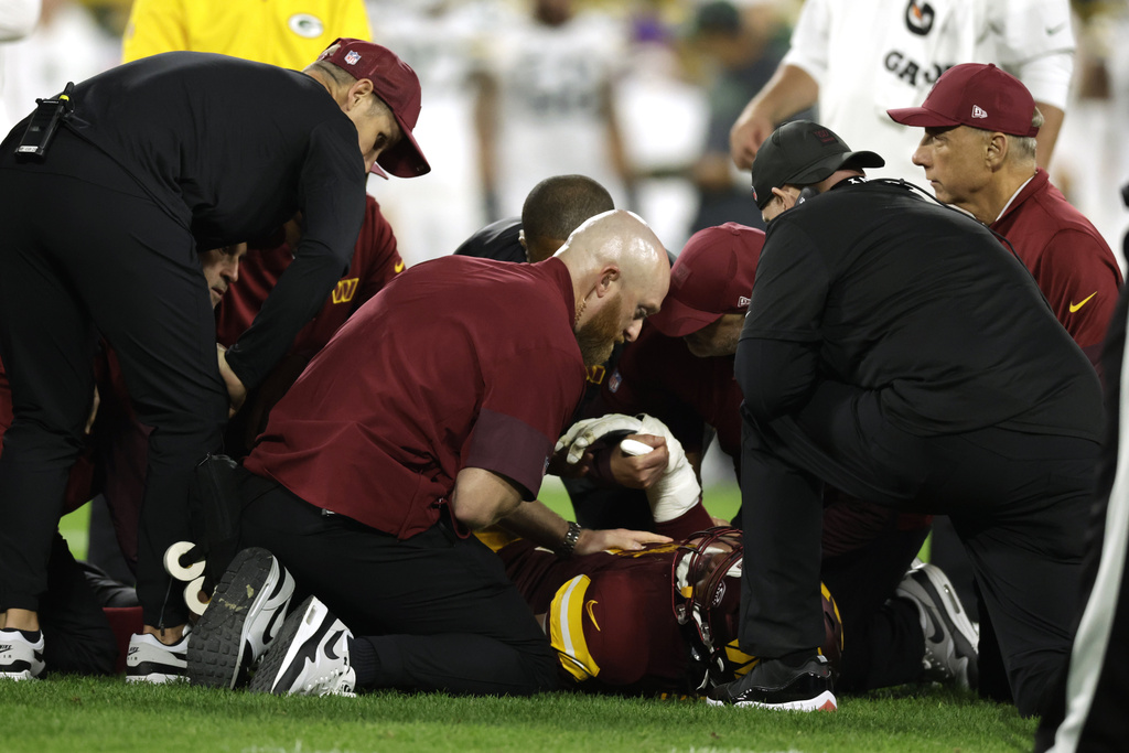 Washington Commanders defensive end Deatrich Wise is injured during the first half of an NFL football game against the Green Bay Packers Thursday, Sept. 11, 2025, in Green Bay, Wis. (AP Photo/Matt Ludtke)