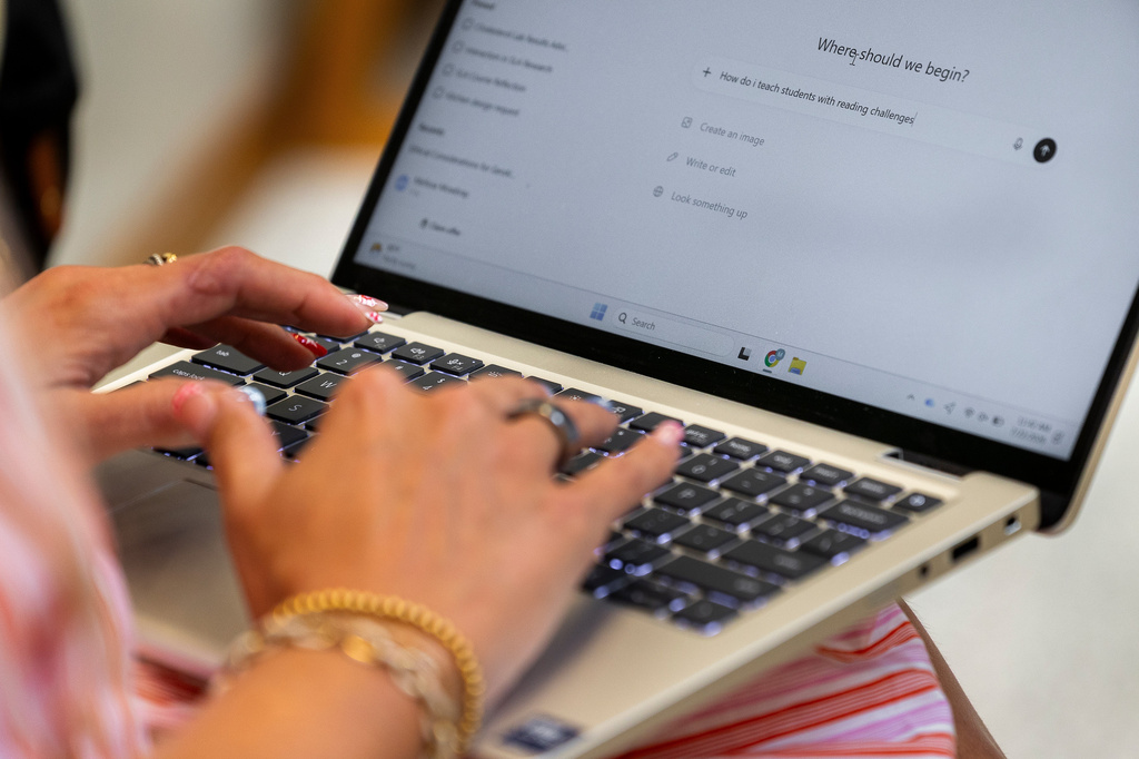 Preschool teacher Melissa Mowbray works with AI on her laptop at Academic Magnet High School during the Charleston County School District Charleston Educator Symposium Wednesday, July 22, 2026 in North Charleston, S.C. (AP Photo/Mic Smith)