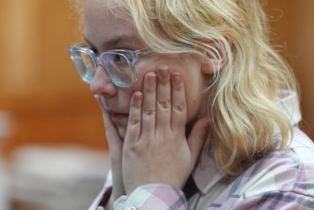 Diana Loginova, an 18-year-old Russian singer of Stoptime street band who served two consecutive 13-day prison sentences on various misdemeanor charges, sits during a court session in St. Petersburg, Russia, Tuesday, Nov. 11, 2025. (AP Photo/Dmitri Lovetsky