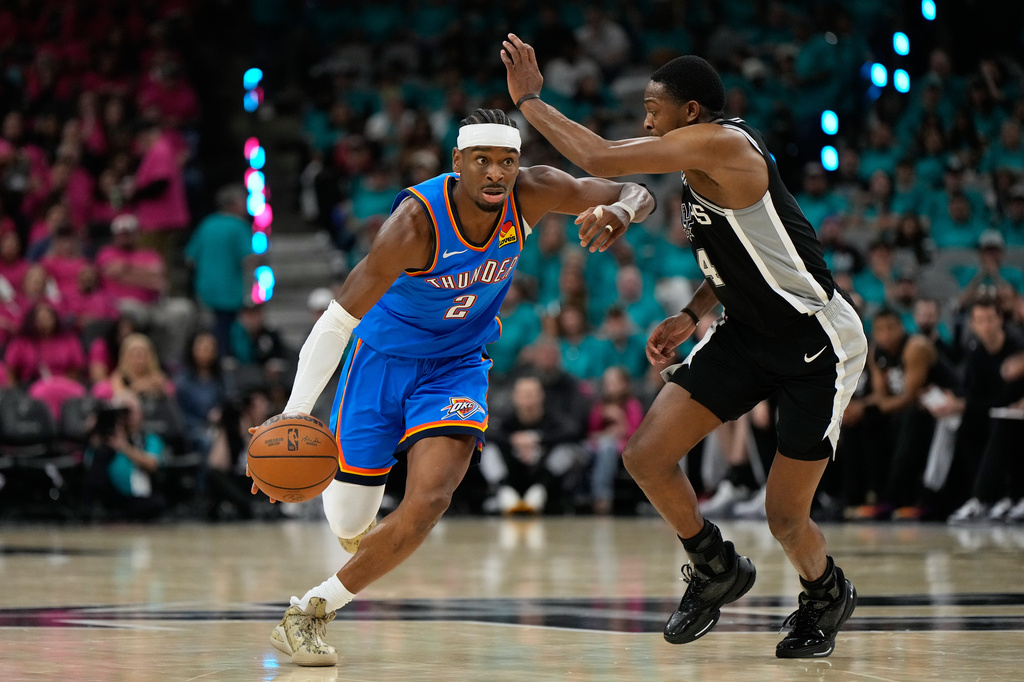 Oklahoma City Thunder guard Shai Gilgeous-Alexander (2) works toward the basket as San Antonio Spurs guard De'aaron Fox (4) defends during the second half of Game 3 in the Western Conference finals NBA basketball playoffs series Friday, May 22, 2026, in San Antonio. (AP Photo/Ashley Landis)